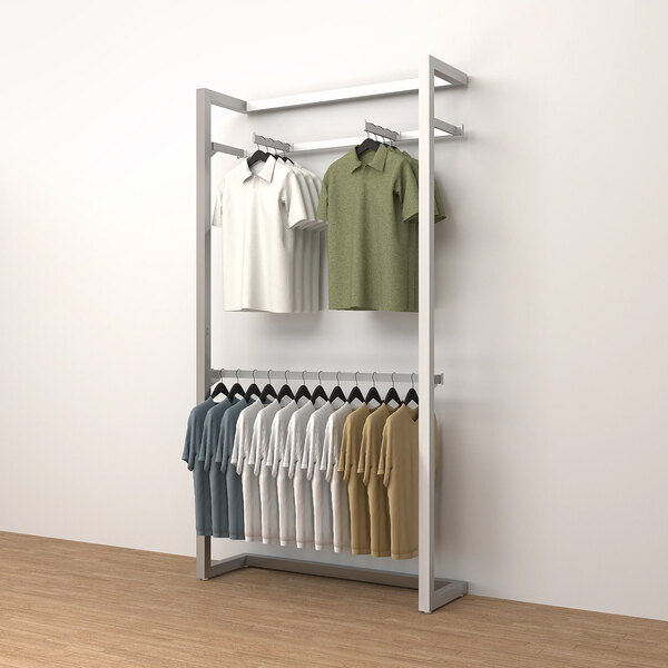 An Econoco wall-mount retail display rack with shirts hanging on it.