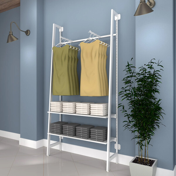A white Econoco wall-mount clothing rack with clothes on it.
