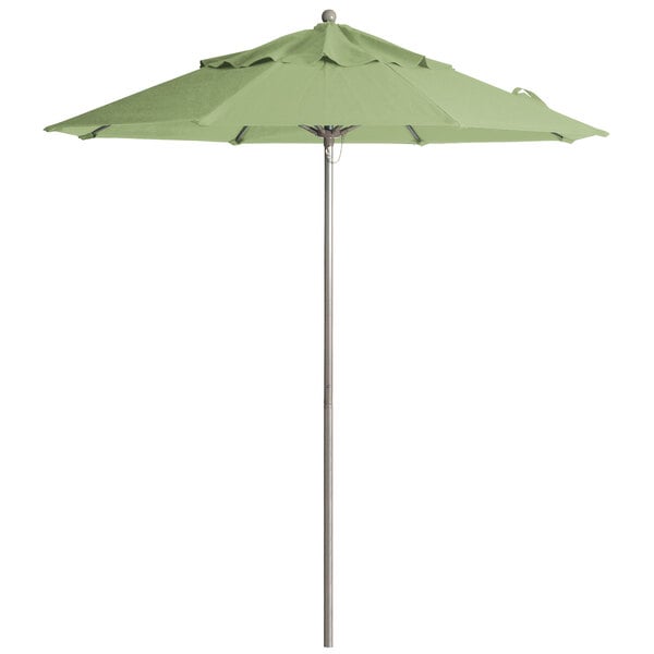 A close-up of a Grosfillex pistachio green umbrella on an aluminum pole.