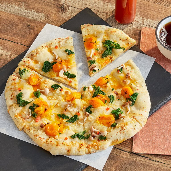 A Rich's Pinsa flatbread pizza with cheese and vegetables on a table.