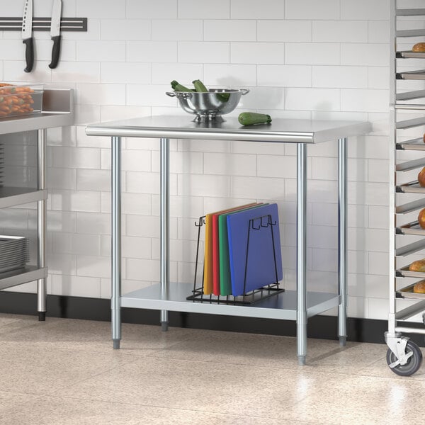 A galvanized steel undershelf on a metal work table.