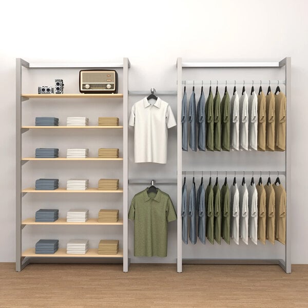 An Econoco wall-mount retail clothing display with shelves, clothes, and shirts on it.