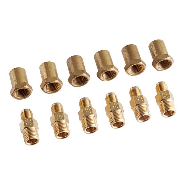 A group of brass threaded fittings including gold and silver pipes and nuts.