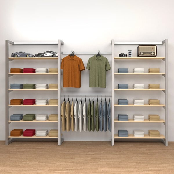 A room with a wall-mount retail display with shelves, clothes, and toys on it.