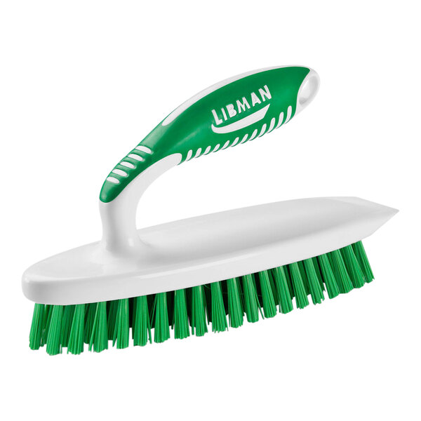 A white Libman iron scrub brush with a green and white handle.