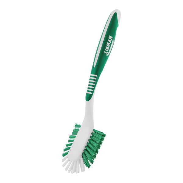 A white and green Libman all-purpose kitchen brush with a handle.