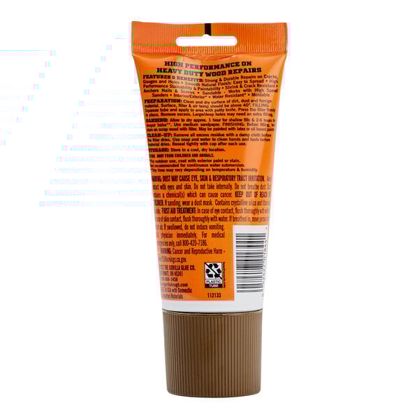 A close-up of a Gorilla Walnut Wood Filler tube with a brown label on a white background.