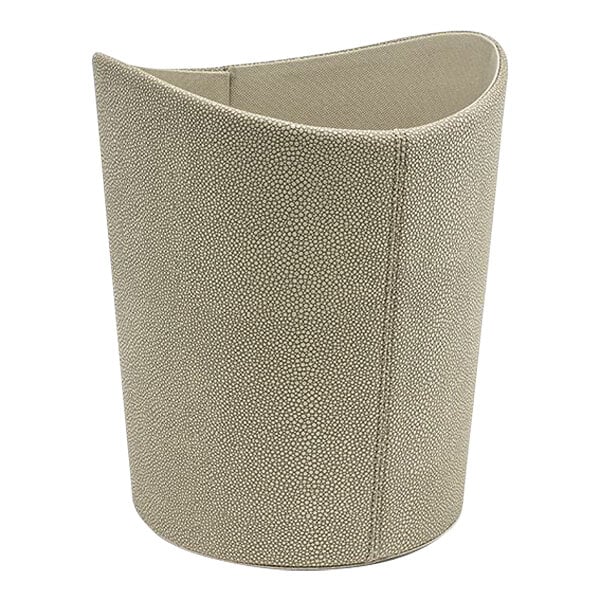 A beige faux shagreen cylinder wastebasket with a curved edge and small handle.