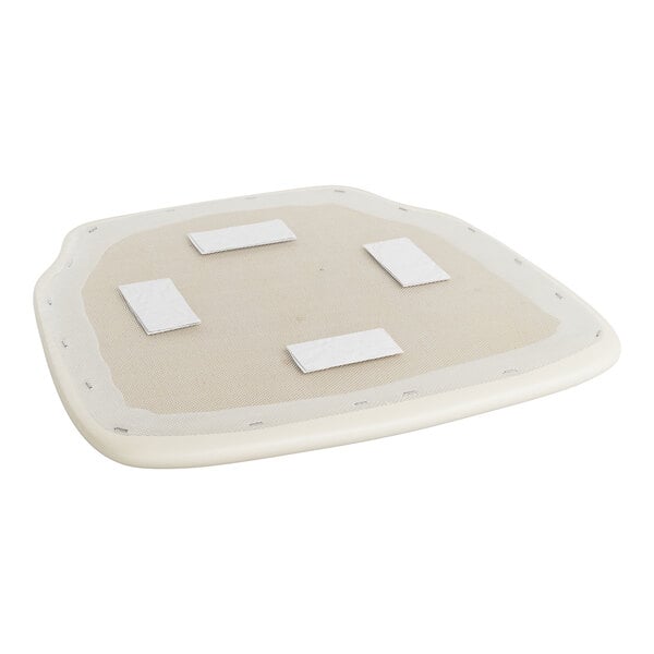 A white cushion with white squares on it.