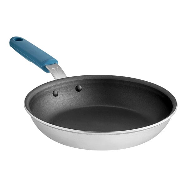 A close-up of a Vigor 10" aluminum frying pan with a blue silicone grip.