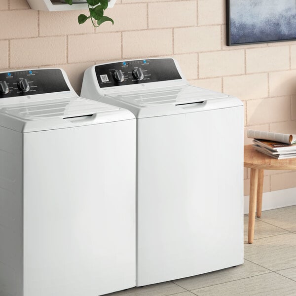 A white GE VTW525ASRWB top load commercial washer with a lid.