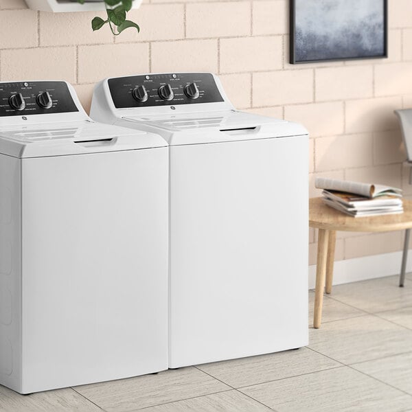 A white GE top load commercial washer with a lid.