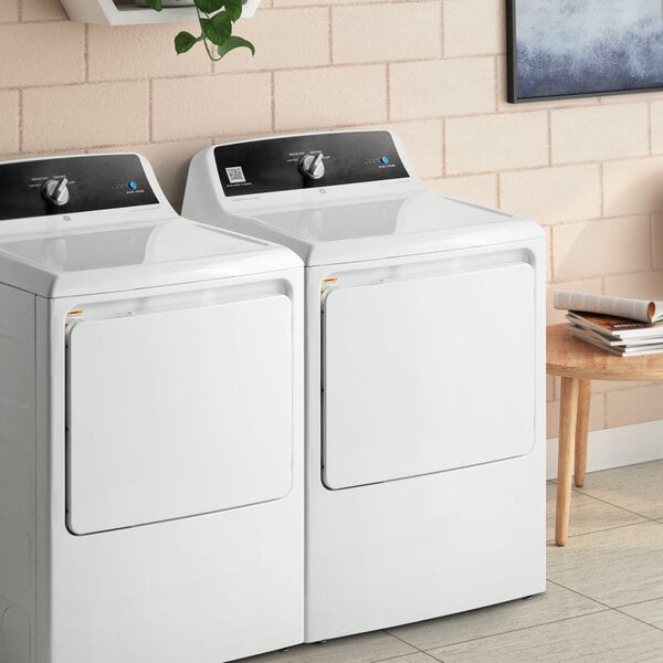 A white GE front load gas-powered commercial dryer.