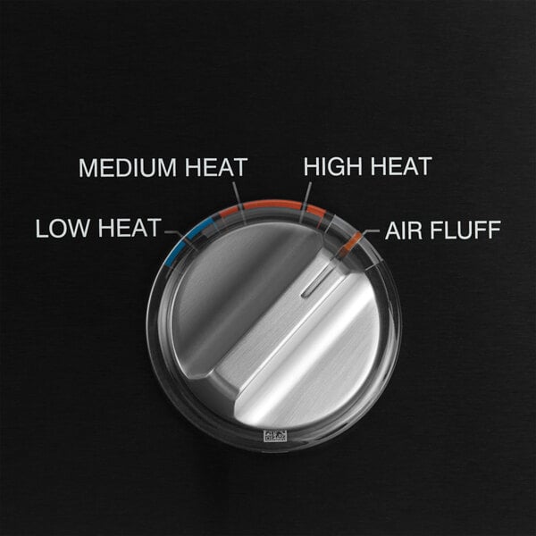 The control panel of a GE front load electric commercial dryer with a dial and temperature gauge.
