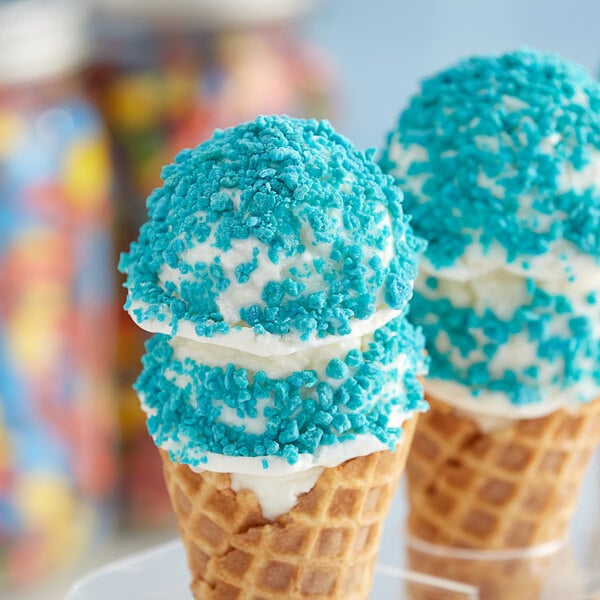 An ice cream cone with Yum Crumbs Berry Blue crumb topping on top.