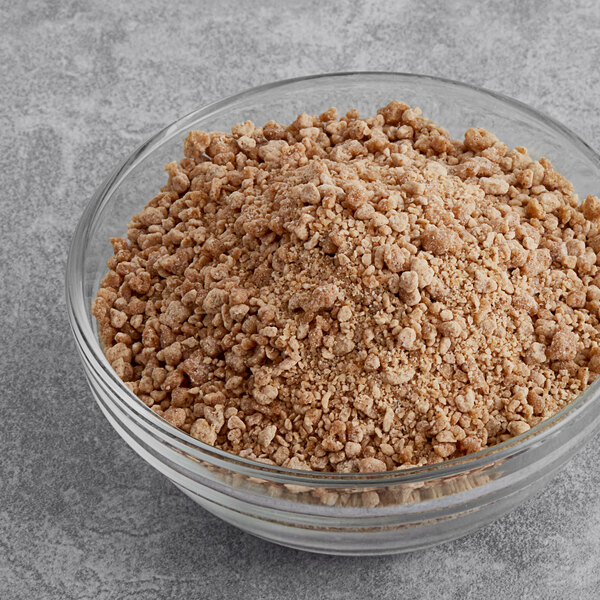 A white bowl of Yum Crumbs cinnamon roll crumb topping.