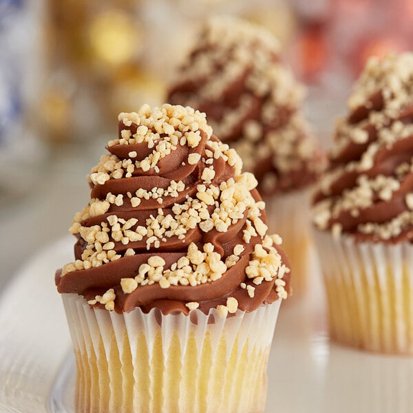 A cupcake with Yum Crumbs Toasted Almond crumb topping on chocolate frosting.