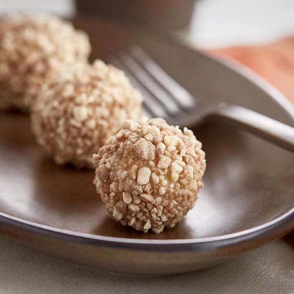 A plate of Yum Crumbs apple pie crumb balls with a fork.