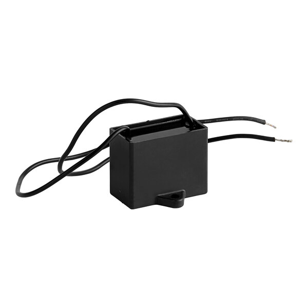 A black Noble Products capacitor with wires.