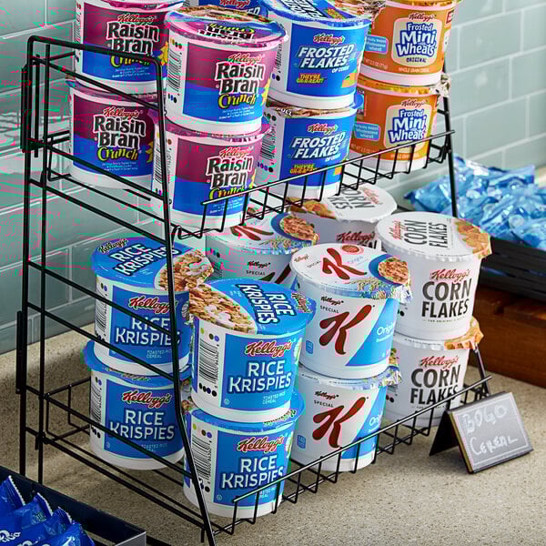 A white rack of Kellogg's cereal cups on a hotel buffet.