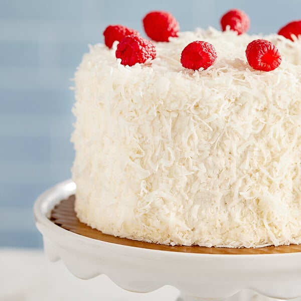 A white cake with Coral Bay sweetened coconut flakes on top.