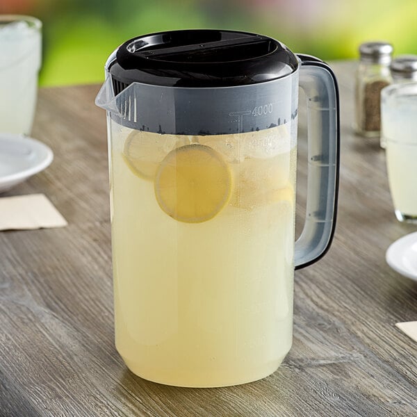 A Choice polypropylene pitcher of lemonade on a table.