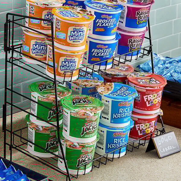 A rack of Kellogg's cereal containers on a shelf.