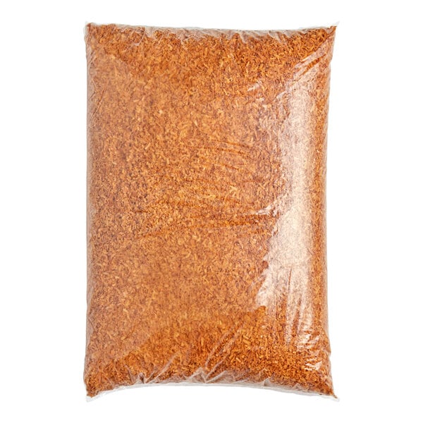 A plastic bag of brown shredded coconut flakes.