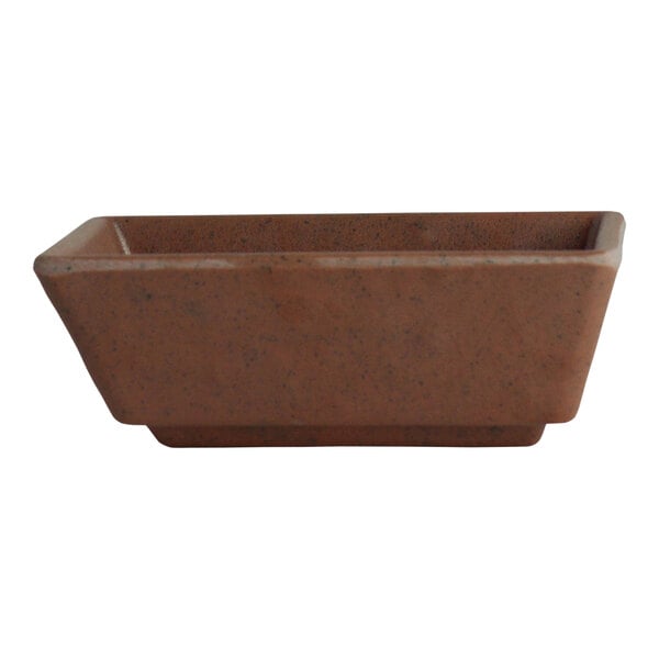 A brown rectangular melamine dish with a brown base on a counter.