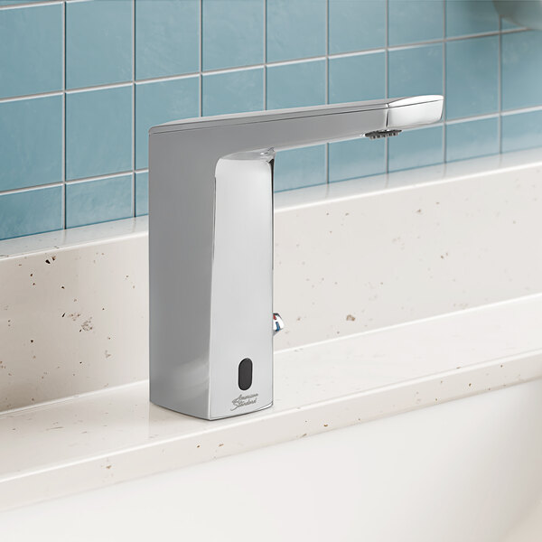 An American Standard Paradigm Selectronic touchless lavatory faucet with a chrome finish on a white counter.