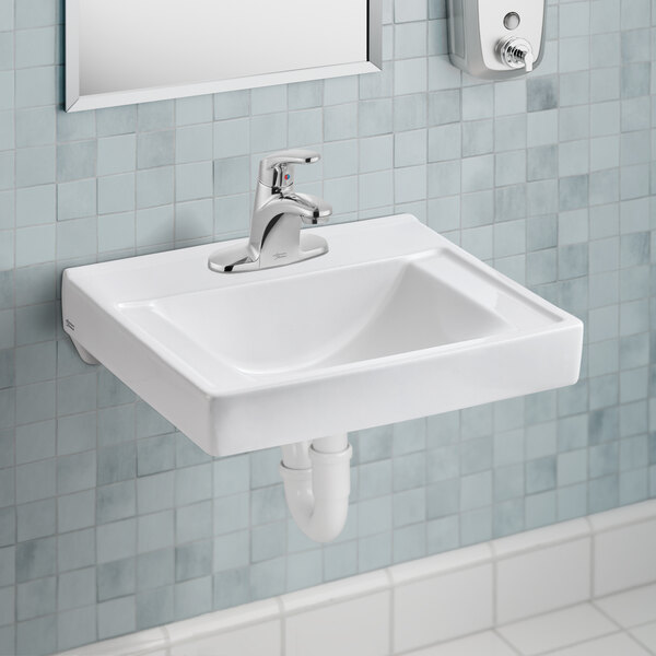 A white American Standard Decorum wall-mount commercial bathroom sink with a silver faucet above.