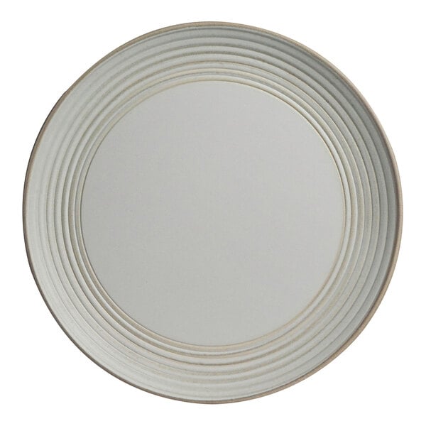 A white plate with a circular pattern on the rim.