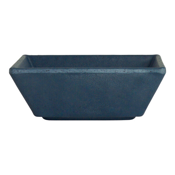 A blue rectangular ramekin with a white background.