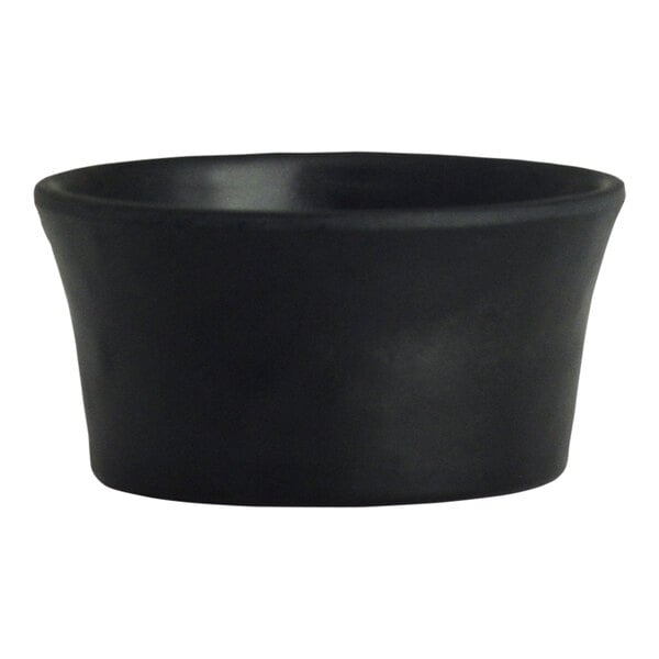 A black melamine round dish with a white background.