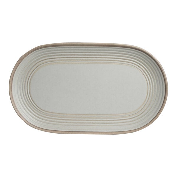A white oval plate with a brown border.