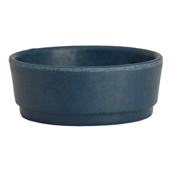 A close-up of a blue Creations Cali ramekin with a speckled surface.