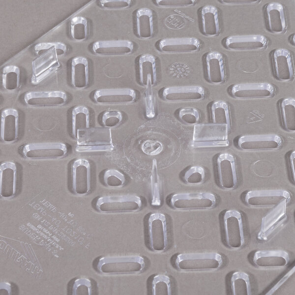 A clear plastic tray with several holes.