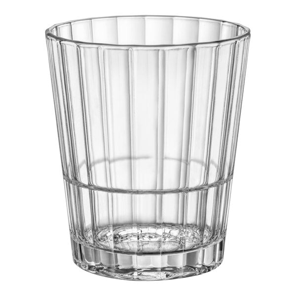 A clear glass tumbler with a ribbed metal rim.