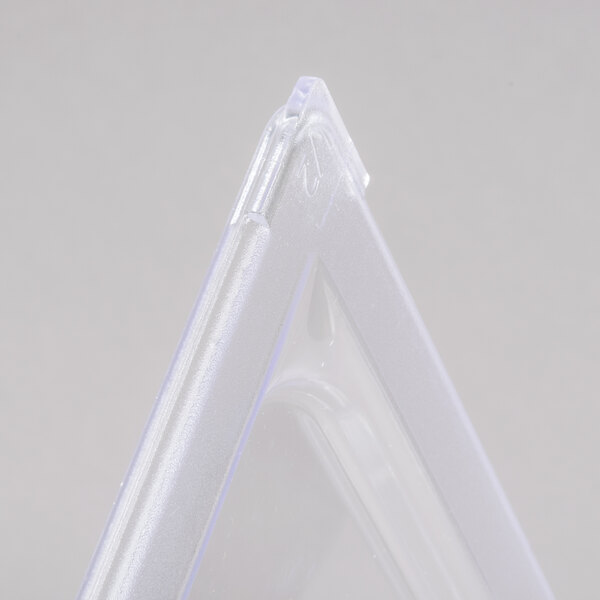 A close up of a clear plastic triangle lid.