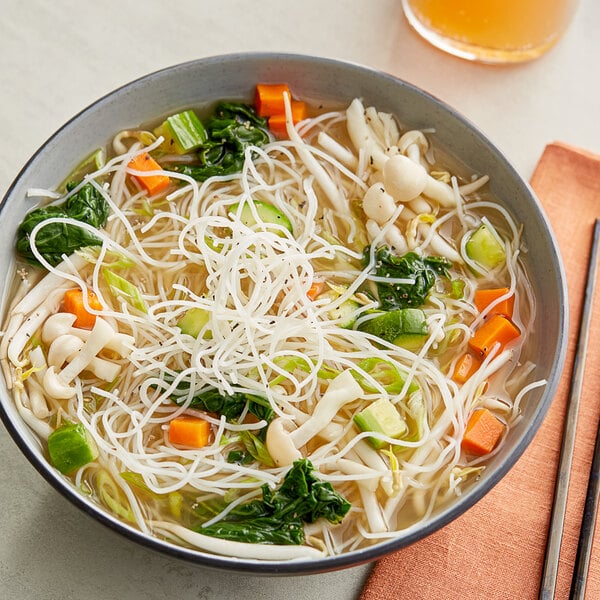 A bowl of Kari-Out Company Rice Stick Vermicelli Noodles with vegetables in soup.