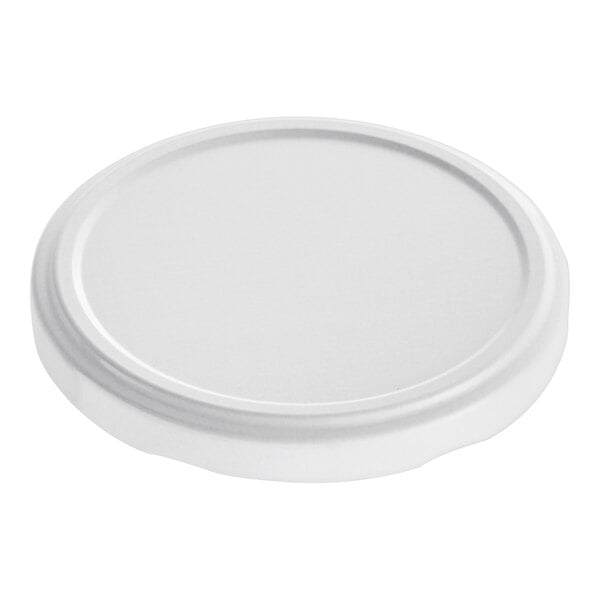 A white metal lid with a plastisol liner on a white surface.