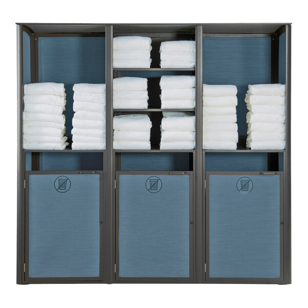 A blue and white Grosfillex towel valet with towels on the shelves.