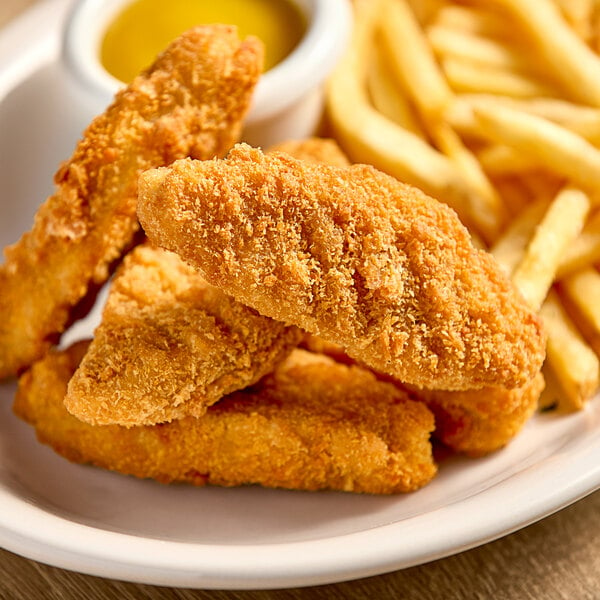 A plate of unMEAT Vegan Chick'n Tenders with french fries.