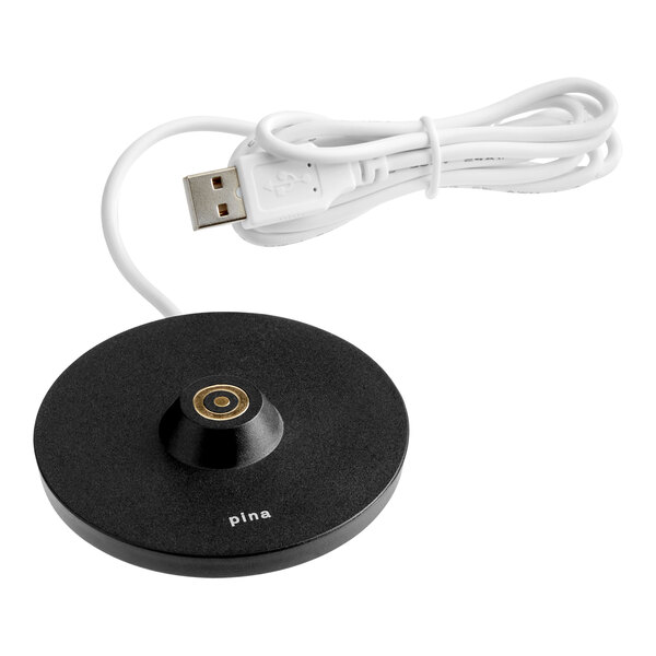 A black circular USB charging base for a cordless rechargeable table lamp.