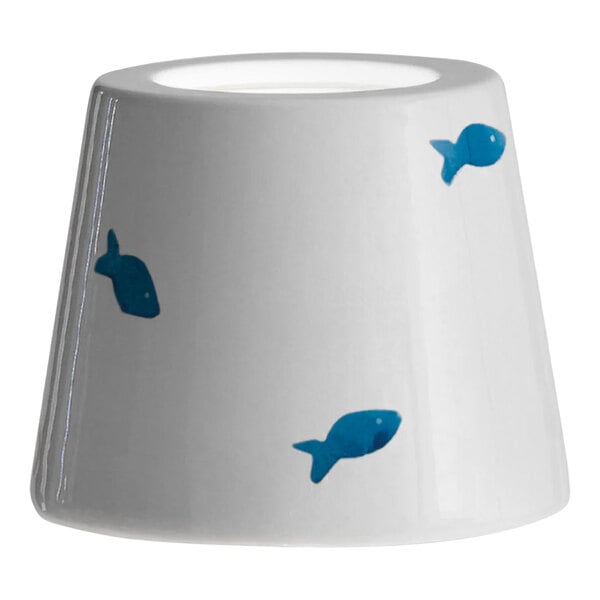 A white lampshade with blue fish on it.