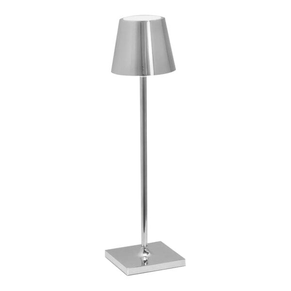 A Zafferano America Poldina Pro table lamp with a silver metal base and cone shaped light.