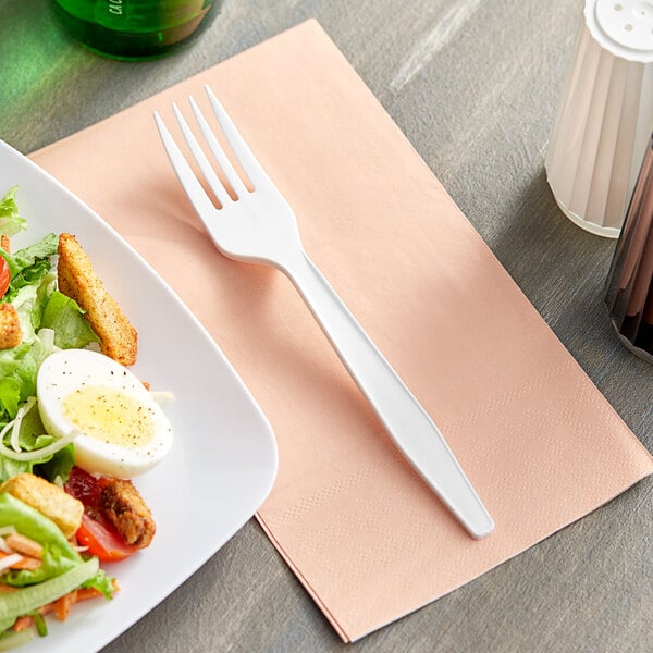 A plate of salad with a Choice white plastic fork.