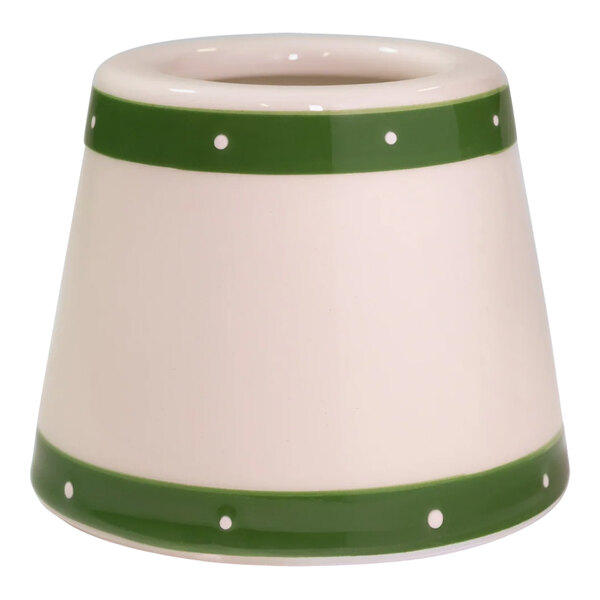 A white lampshade with green dots on the inside.