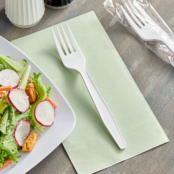 A white plastic plate with a salad and a Choice white plastic fork.