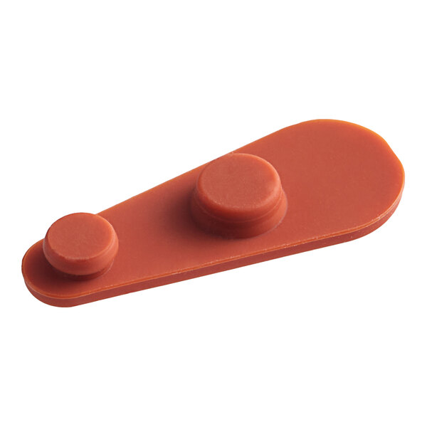 A close-up of a red plastic Vigor Vent Closure with two holes.